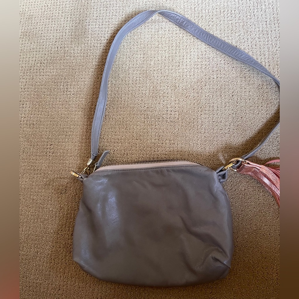 Leather medium size gray purse with copper sash.
